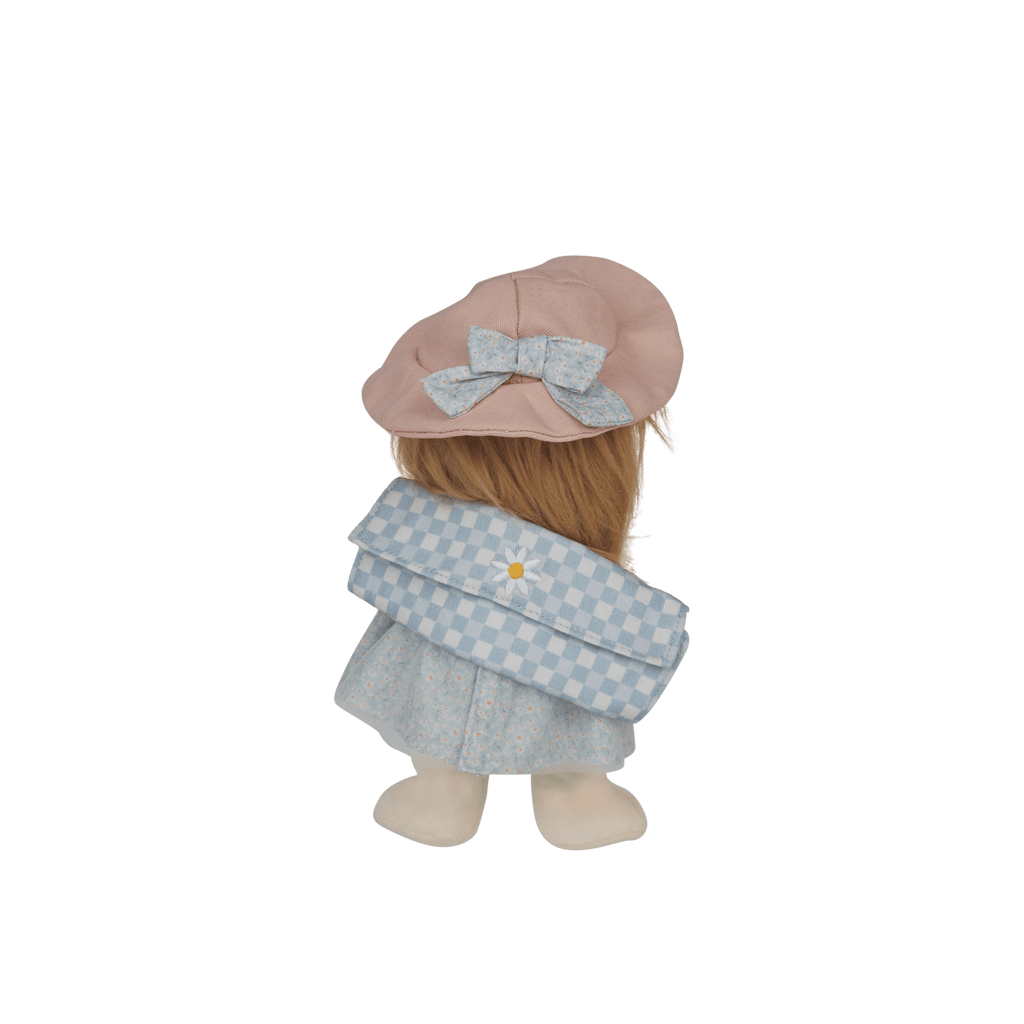 Stuffed toy with a pink hat and light blue dress on a white background