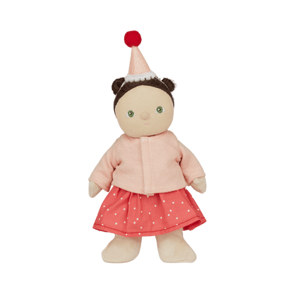Stuffed doll with a pink outfit and red hat on a white background