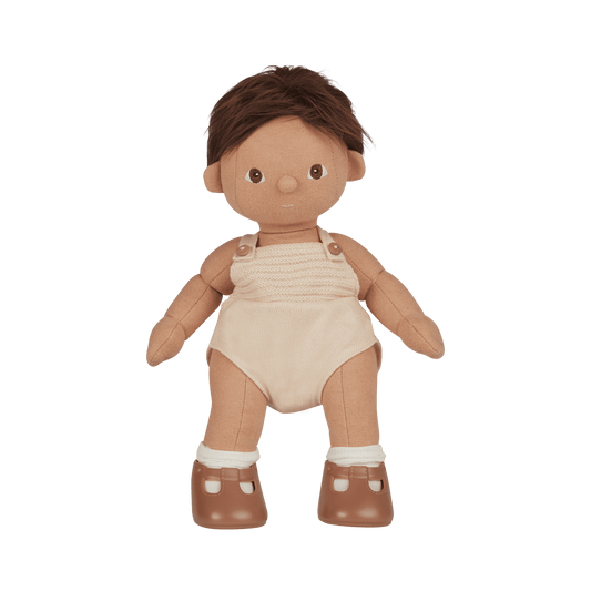 Toy doll with brown hair, beige romper, and brown shoes on a transparent background