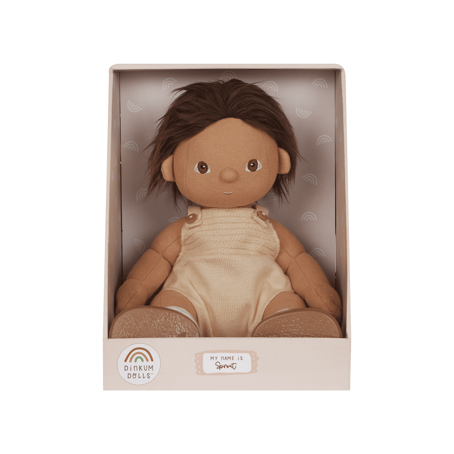 Doll in a beige box with a green background