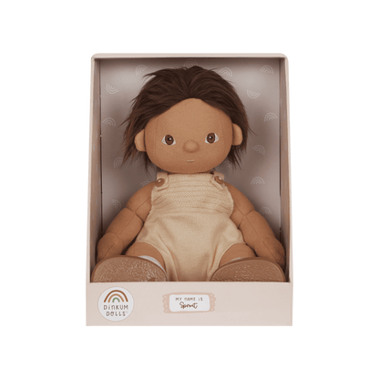 Doll in a beige box with a green background