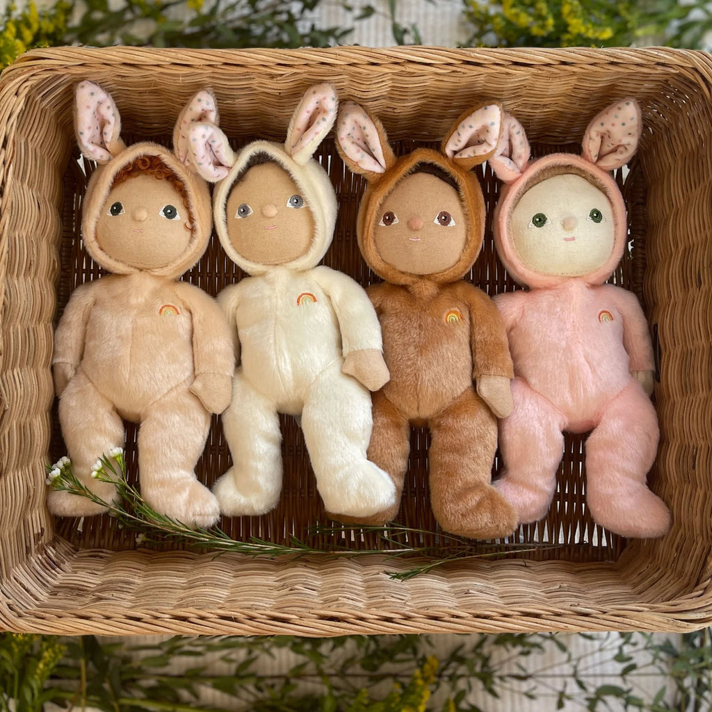 Four plush toys in animal costumes sitting in a woven basket.