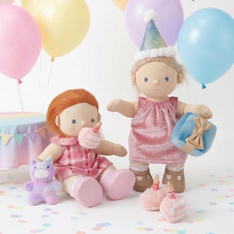 Two dolls with balloons and party supplies on a colorful background