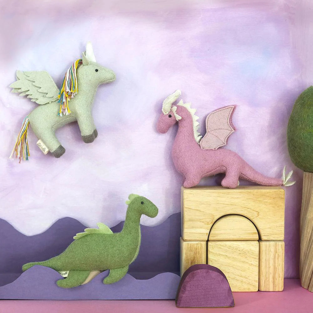 Toy dragon, unicorn, and dinosaur on a colorful background