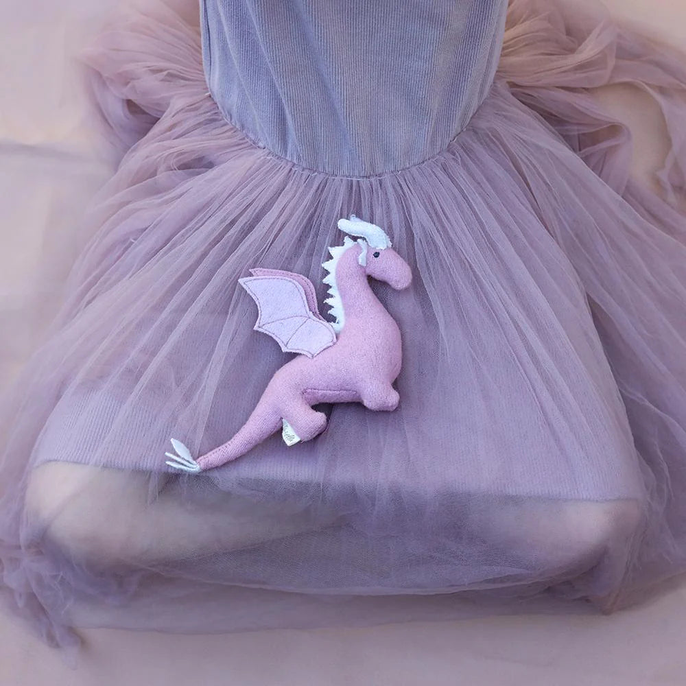 Pink dragon plush toy attached to a tulle skirt