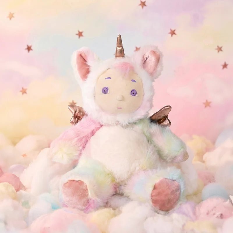 Plush toy unicorn with rainbow colors and stars in the background