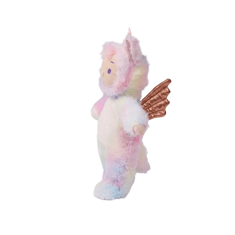 A plush unicorn toy with pastel pink, blue, and yellow tie-dye fur, featuring a small rose gold wing on its back, set against a plain white background.