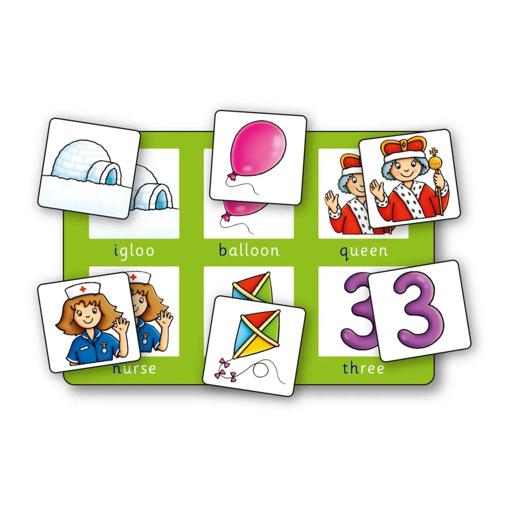 Educational card game with pictures and words on a green mat