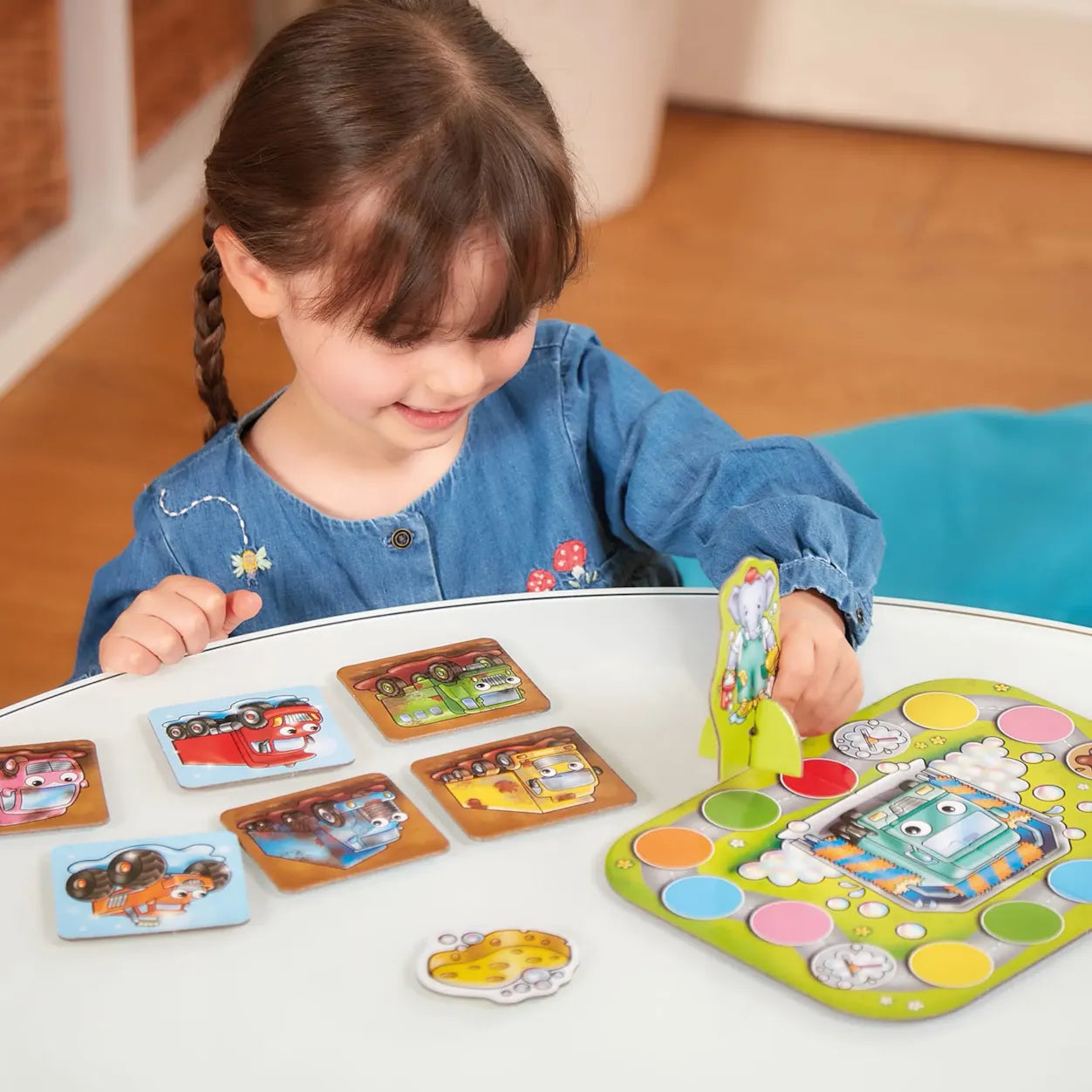 Child playing with a colorful educational toy at a table.