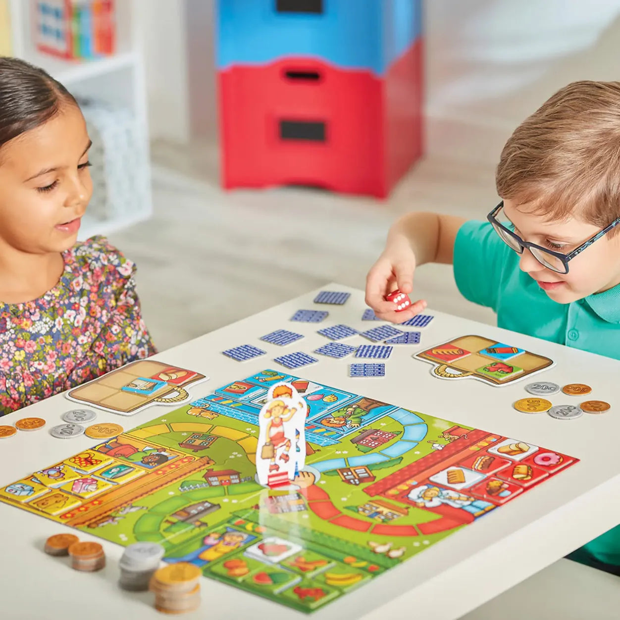Two children playing a board game together at a table.