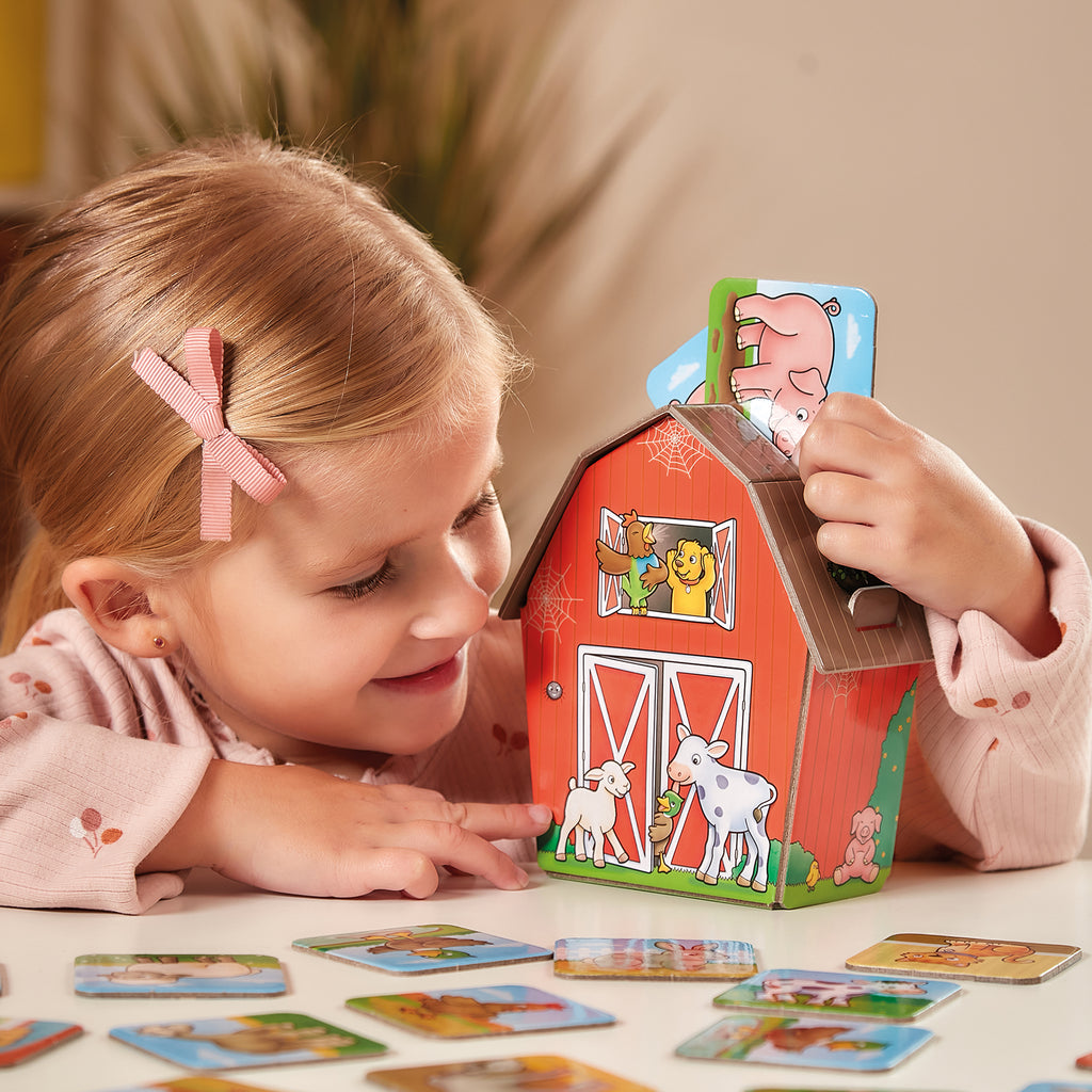 Child playing with a farm-themed card game