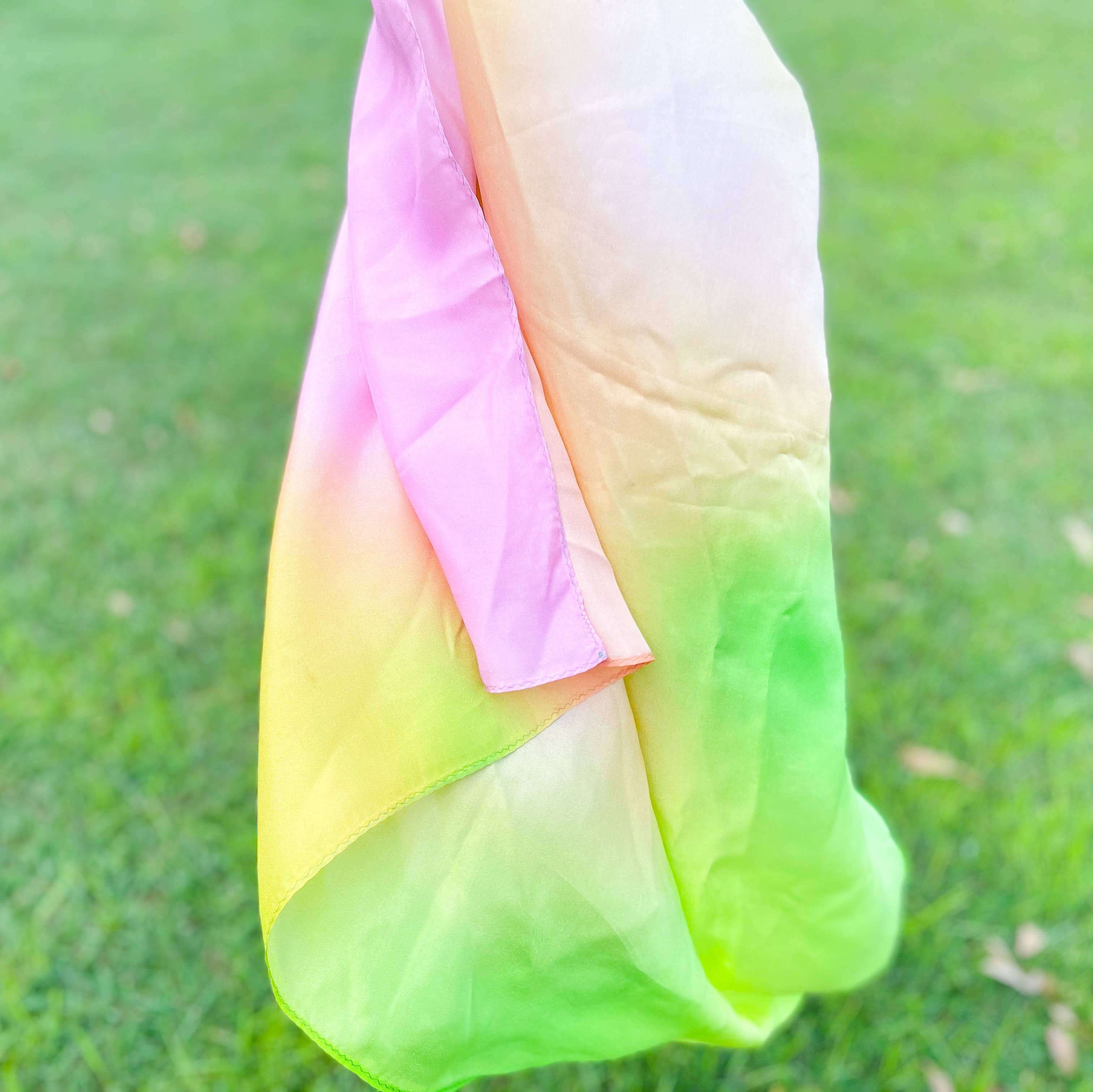 Gradient fabric in pink, orange, and green on a grassy background