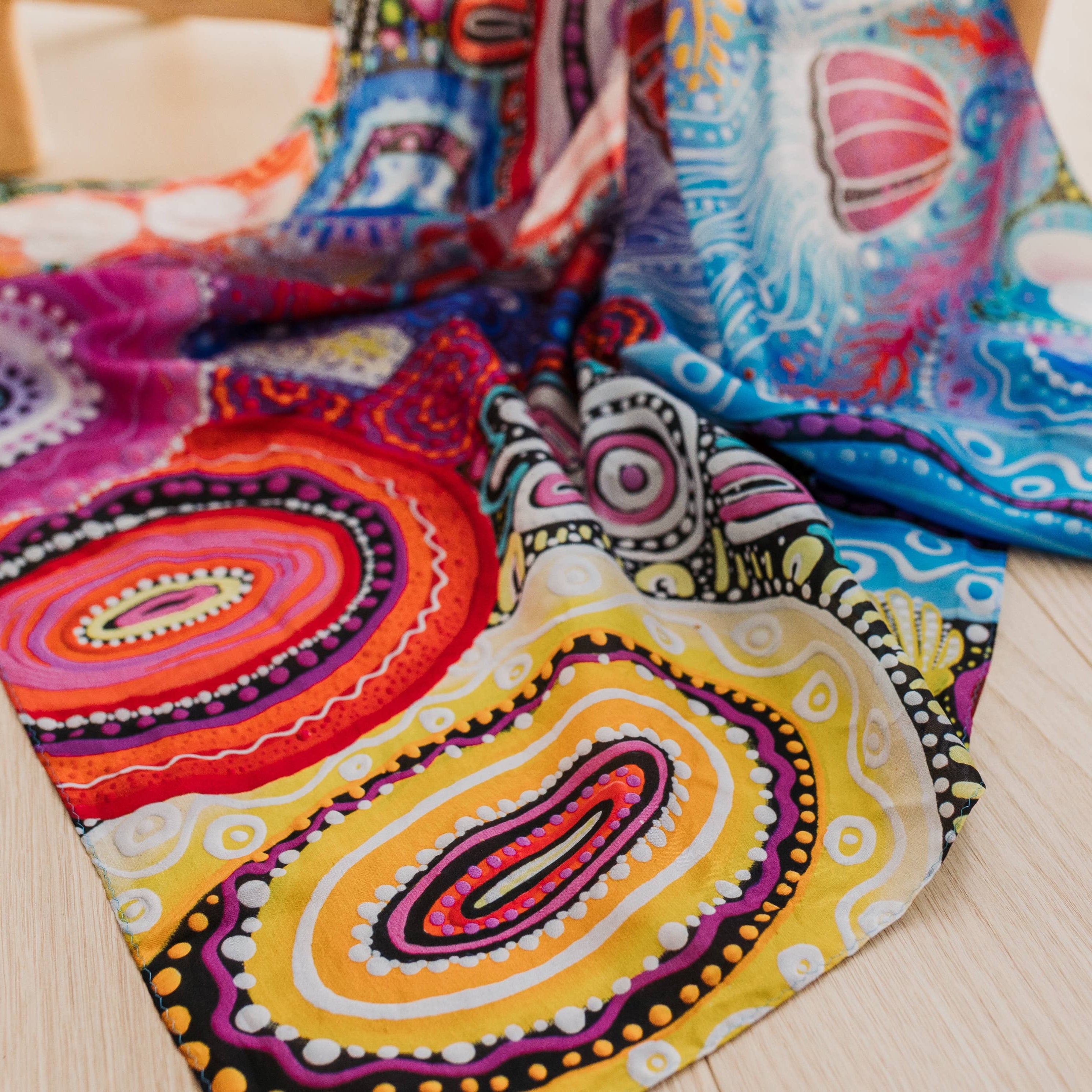 Colorful patterned fabric on a wooden floor