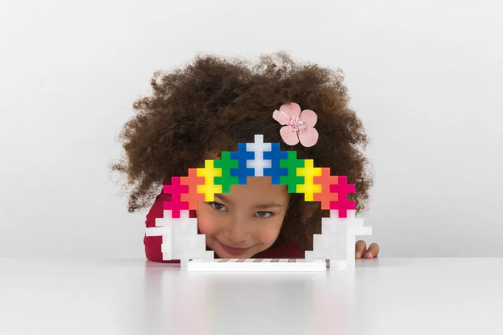 Child with colorful puzzle piece headband on a white background