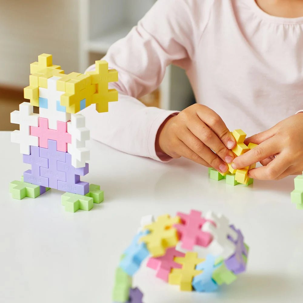 Child playing with colorful puzzle pieces on a table