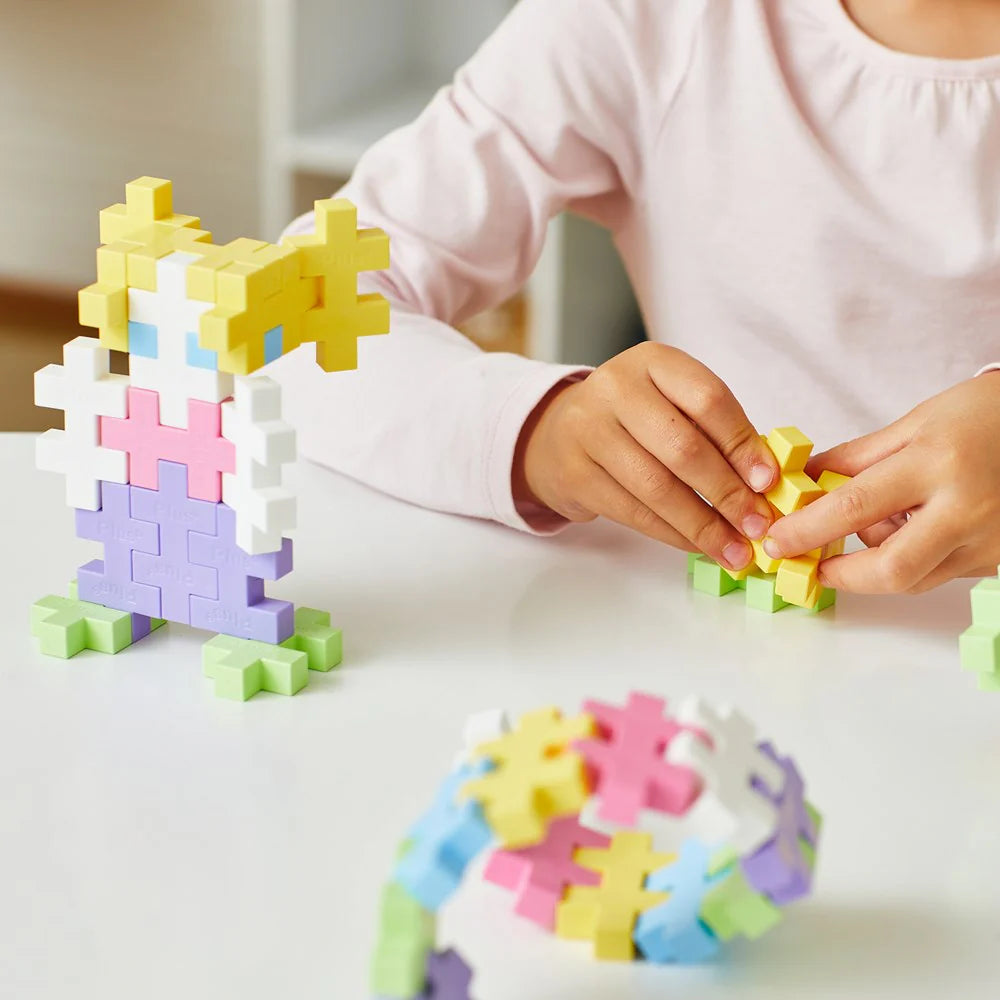 Child playing with colorful puzzle pieces on a table