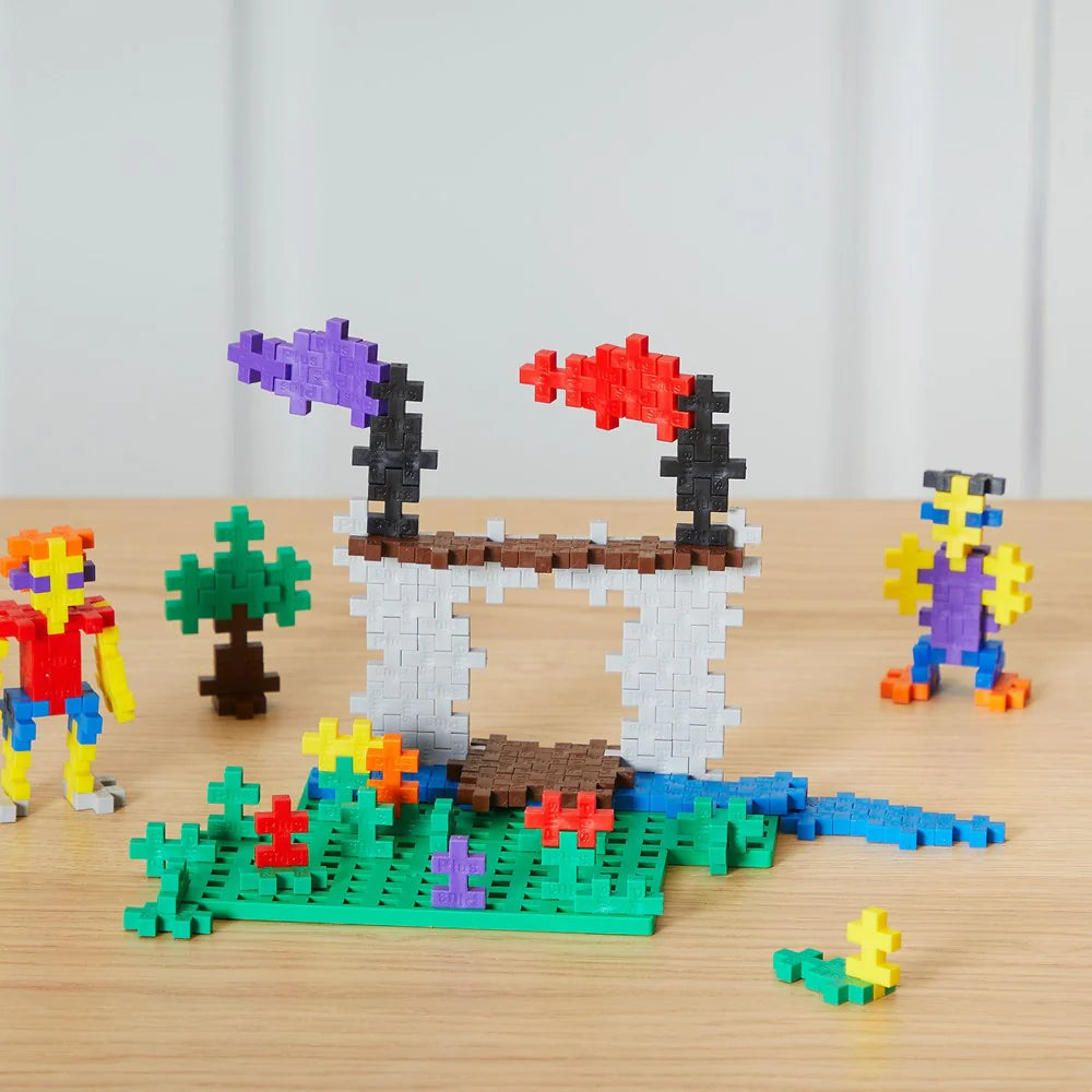 Colorful toy building blocks on a wooden surface with a white curtain background