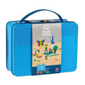 A blue metal suitcase with a construction toy set displayed on the front, labeled Plus-Plus with 600 pieces.