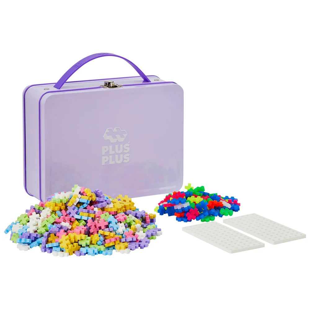 Colourful building blocks with a purple storage box on a white background