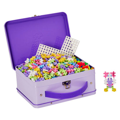 Purple toy box open with colourful toys spilling out on a white background