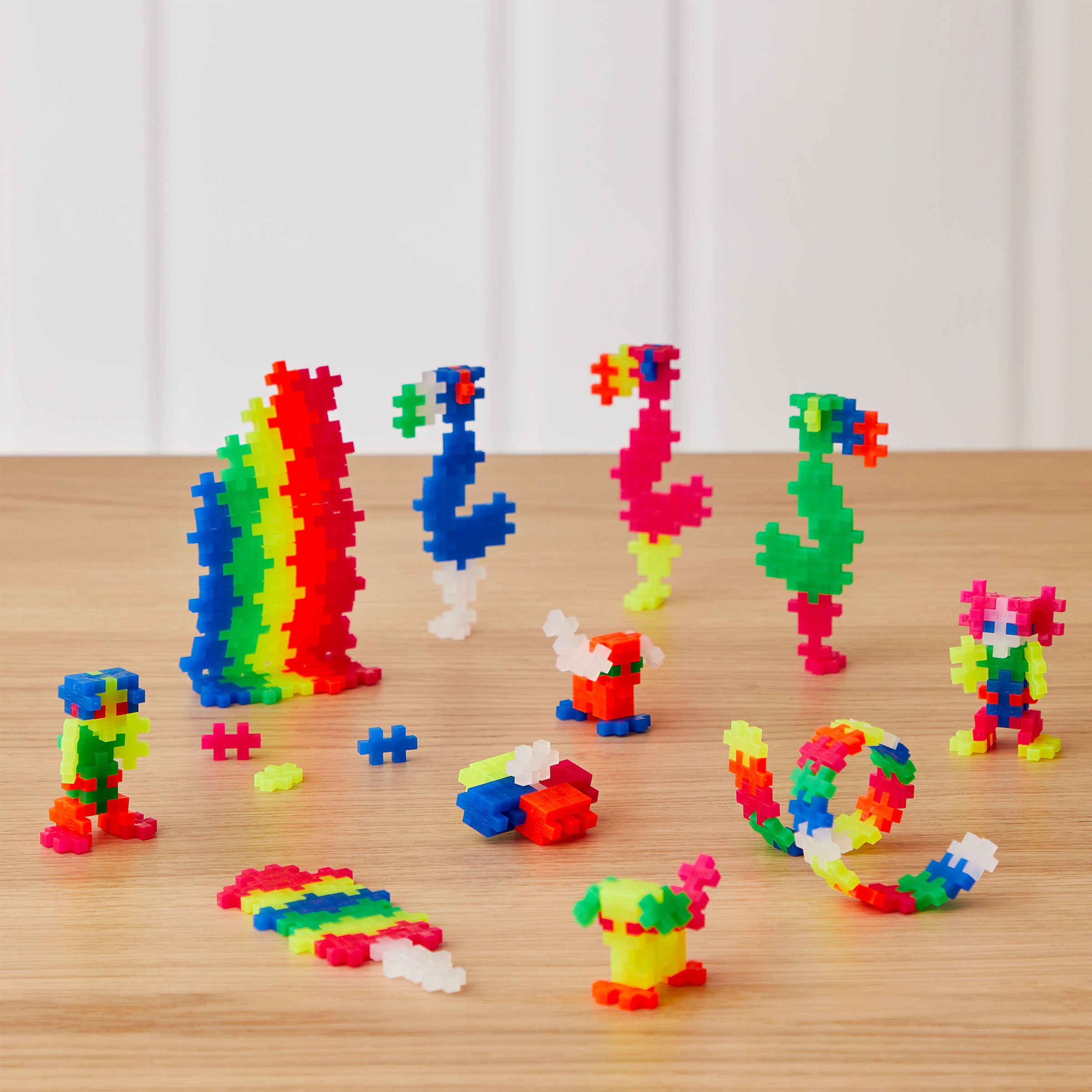 A variety of colorful construction block toys arranged on a table, showcasing different 3D constructions and puzzle configurations.