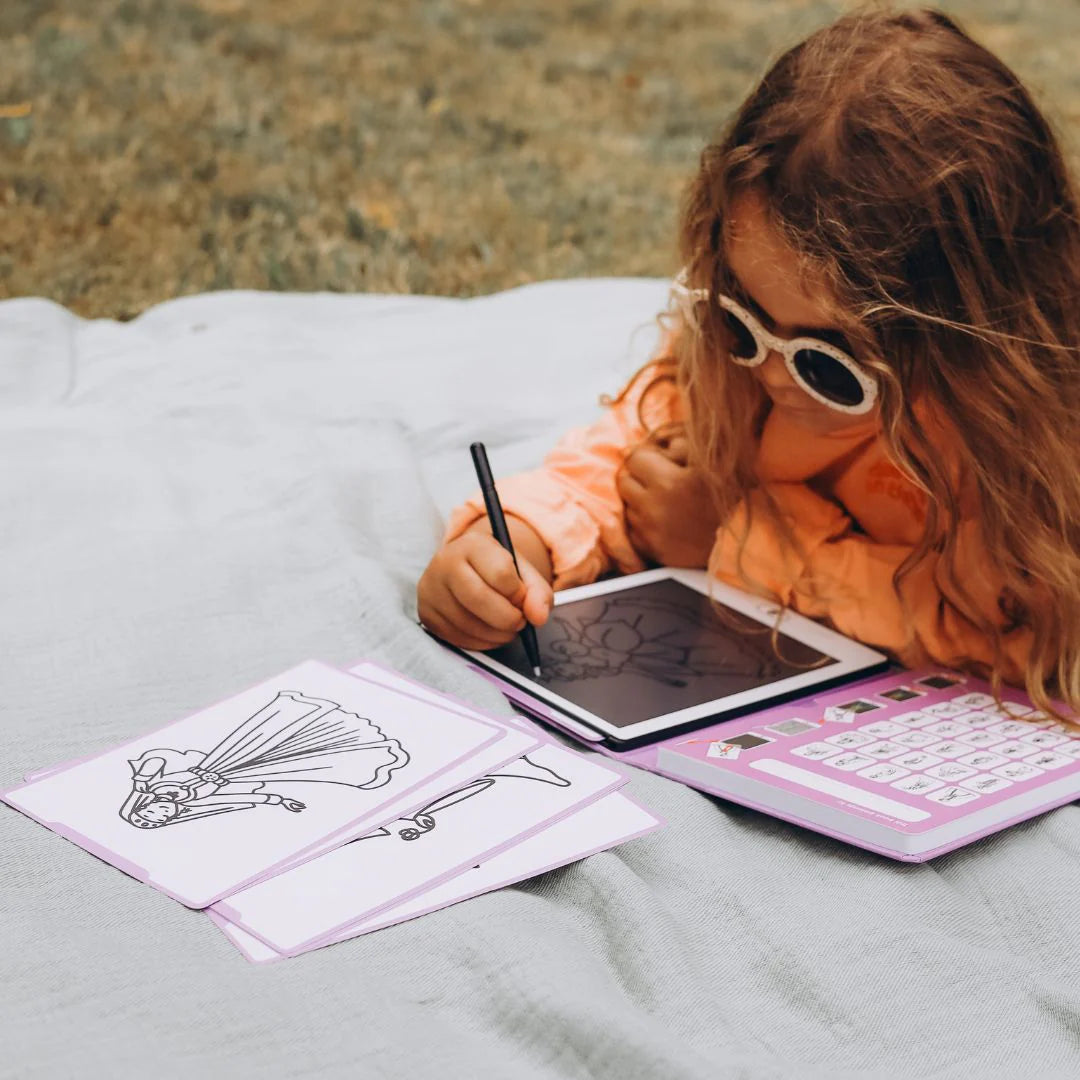 Child drawing on a tablet with a stylus outdoors