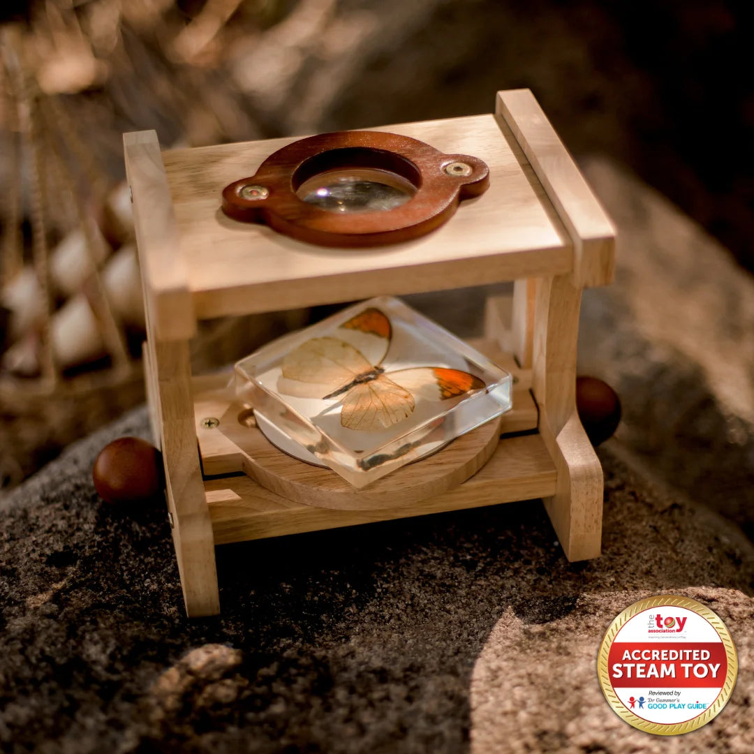 Wooden toy with a circular mechanism on a textured surface.