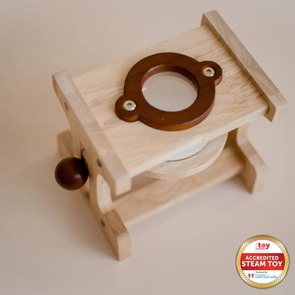 Wooden toy with a circular wooden piece on top and a label on a plain background