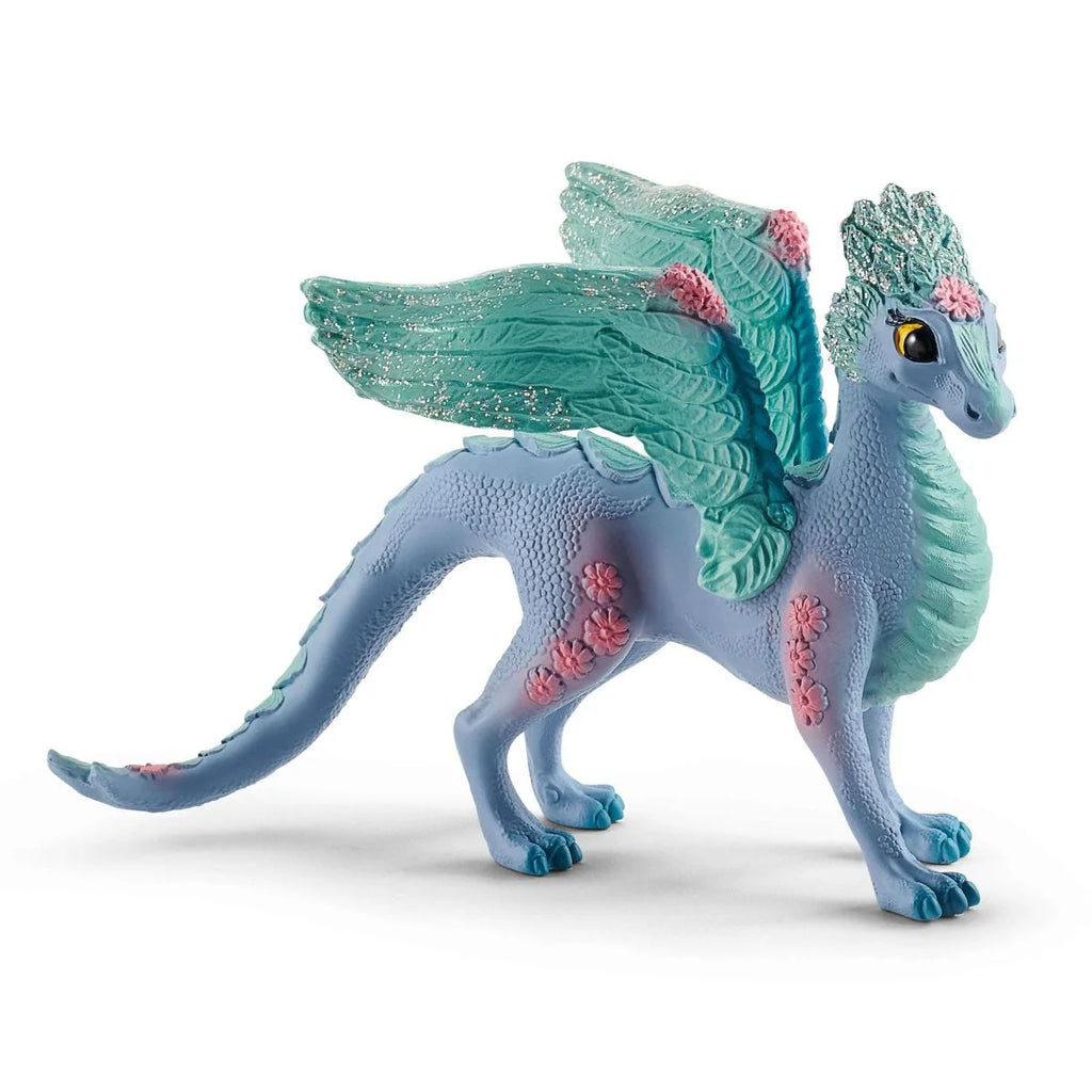 Toy dragon figurine with blue and green colors on a white background