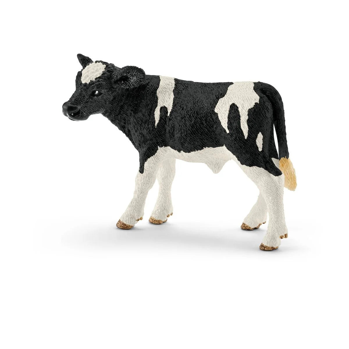 Black and white cow figurine on a white background