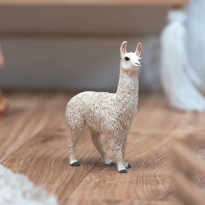 Model of a llama on a wooden surface