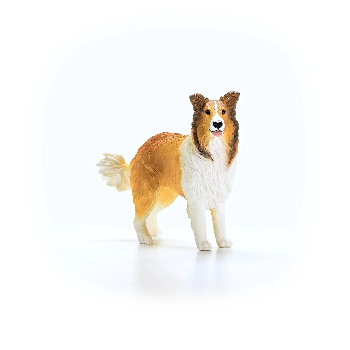 Collie dog figurine on a white background
