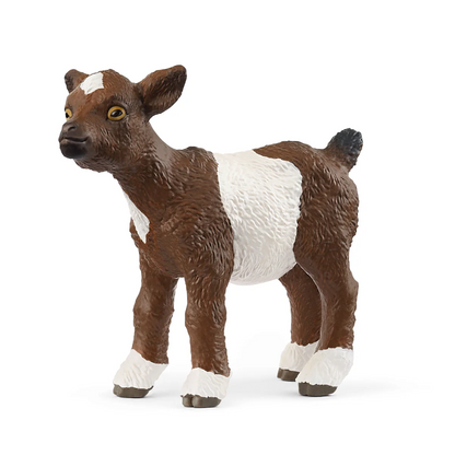 Toy figure of a brown and white goat on a white background