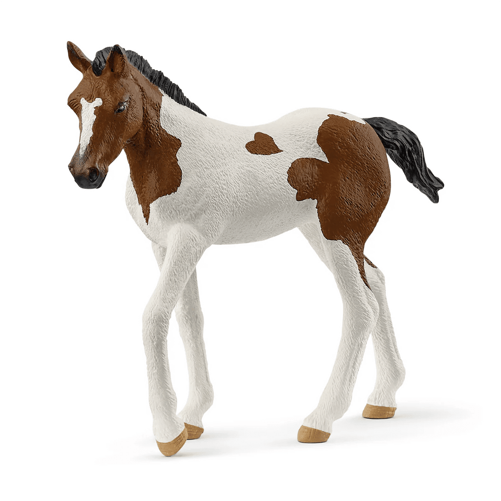 Model horse with brown and white pattern on a white background