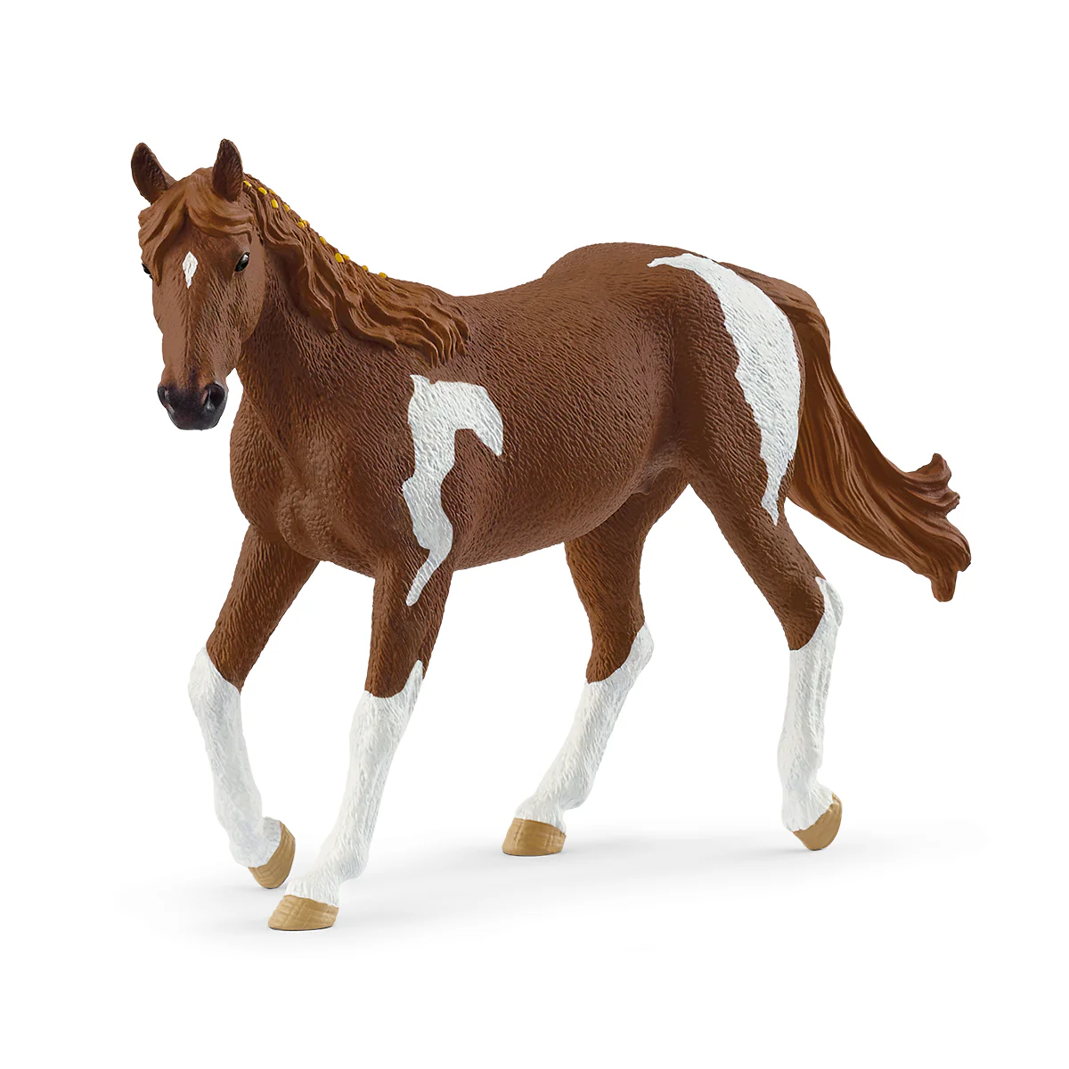 Brown horse figurine with white markings on a white background