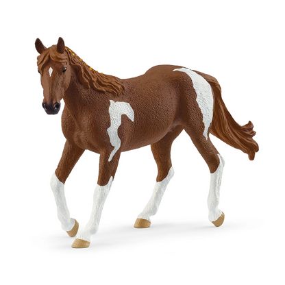 Brown horse figurine with white markings on a white background