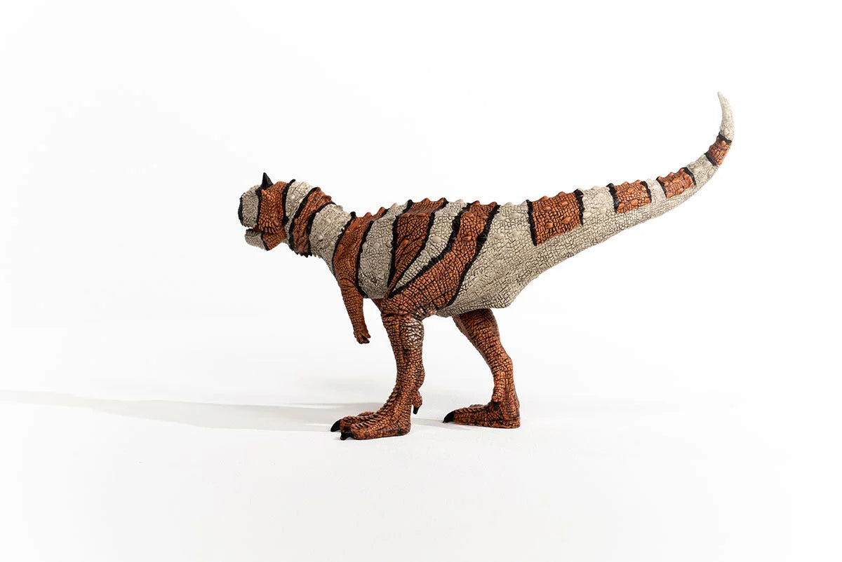 Dinosaur toy figure with striped pattern on a white background