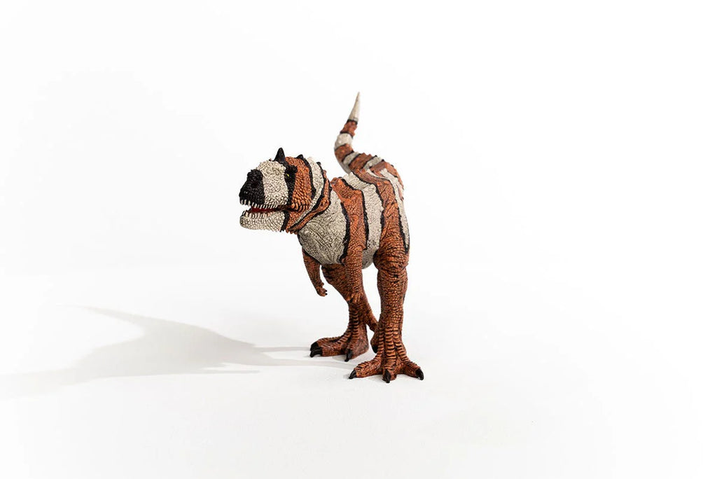 Plush toy dinosaur with a patterned design on a white background