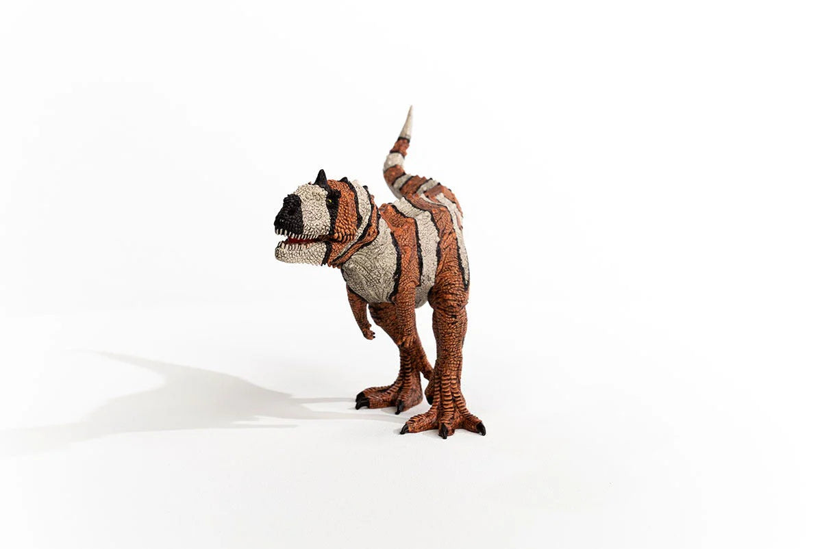Plush toy dinosaur with a patterned design on a white background
