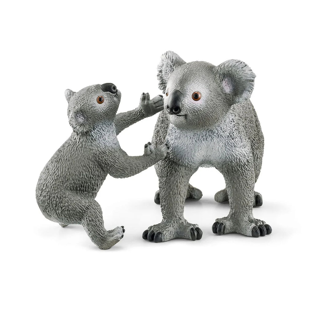 Two koala figurines on a white background