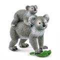 Model of a koala with a baby on its back, standing on a branch.