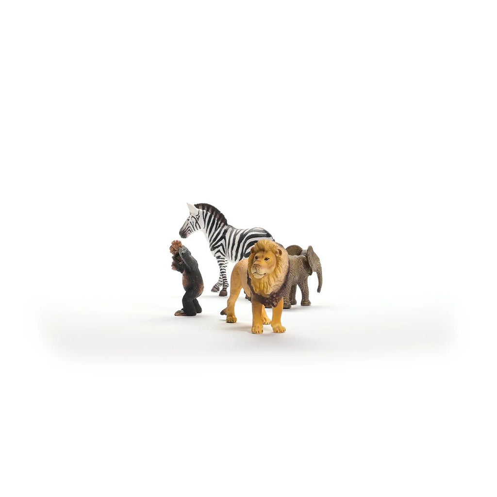 Toy figures of a lion, zebra, and elephant on a white background