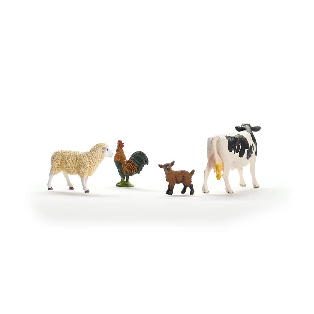 Set of toy farm animals including a sheep, rooster, goat, and cow on a white background