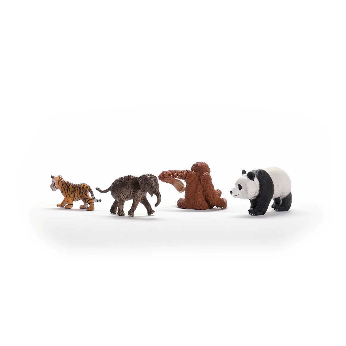 Toy figures of a tiger, elephant, monkey, and panda on a white background
