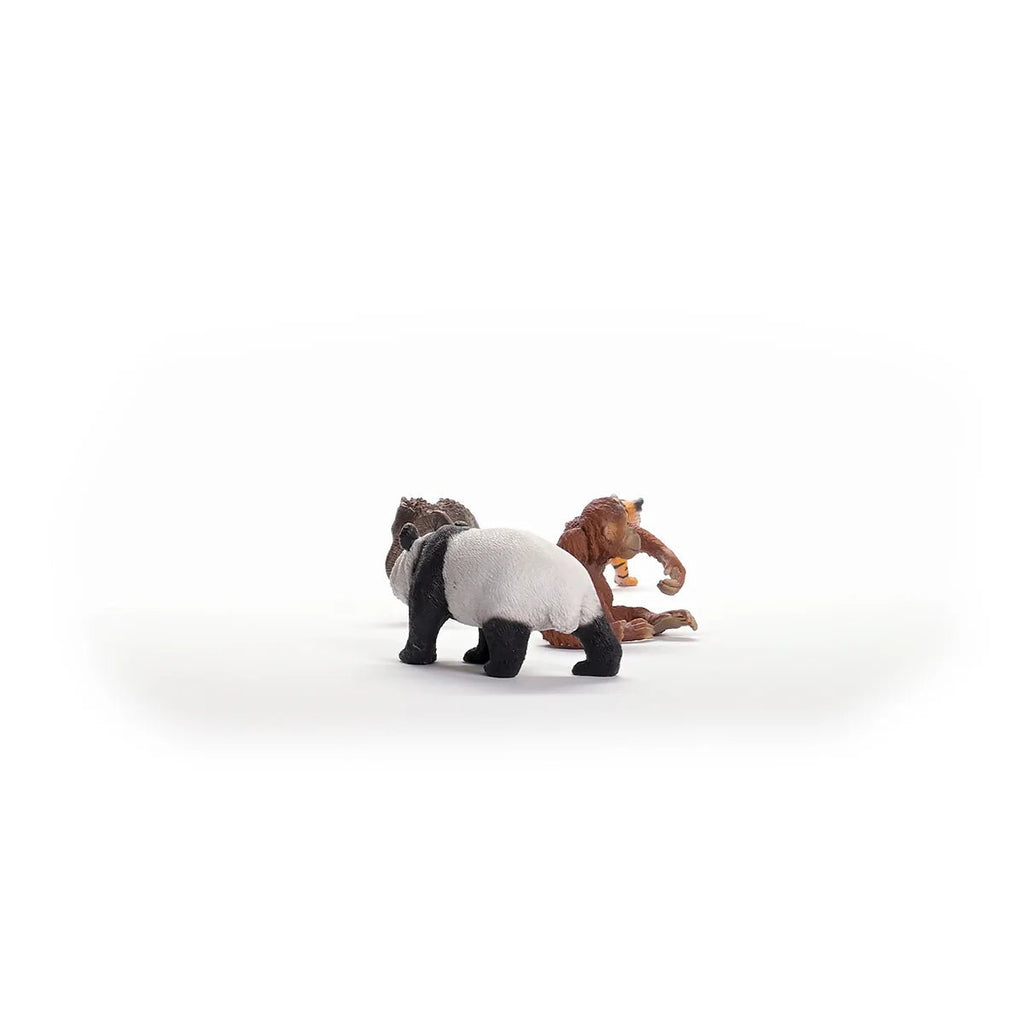 Two toy figures of a panda and a monkey on a white background