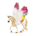 Unicorn figurine with rainbow wings on a white background