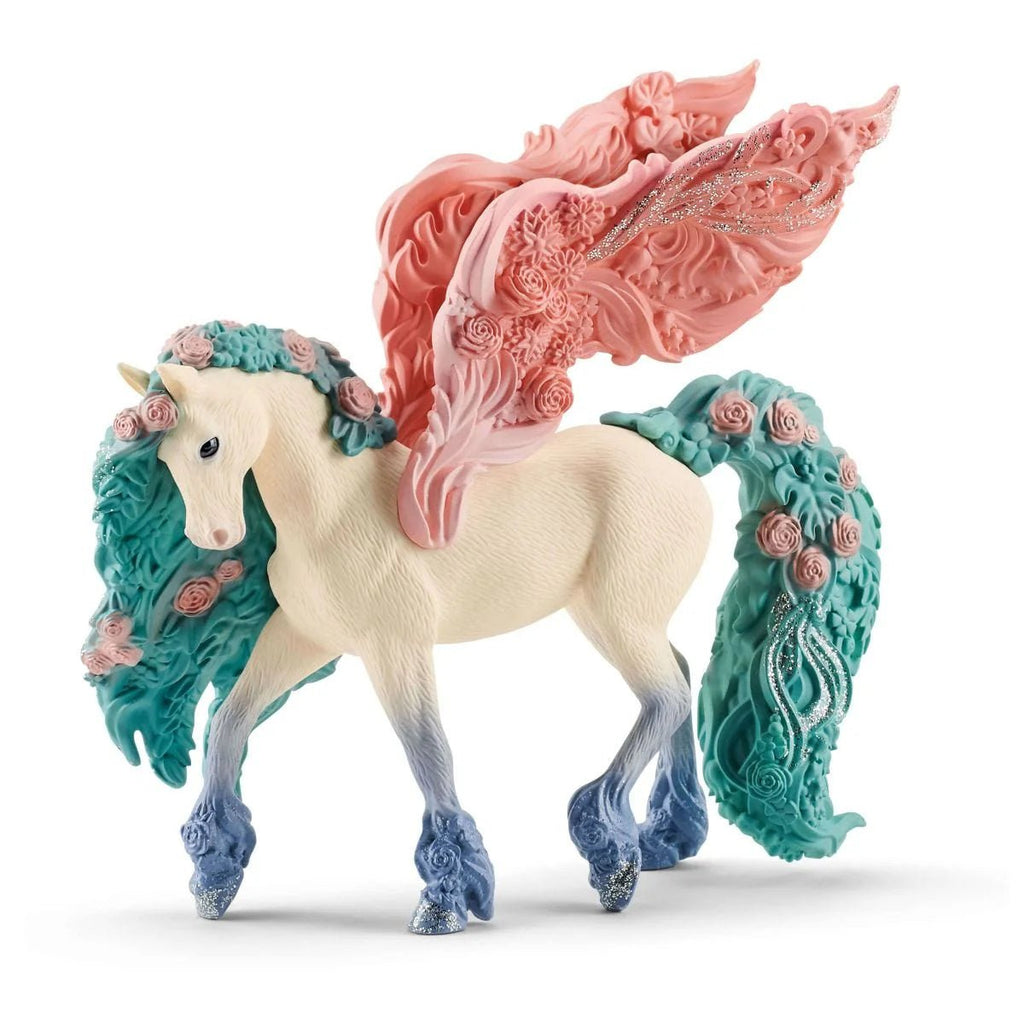 Unicorn figurine with pink and teal wings and mane on a white background
