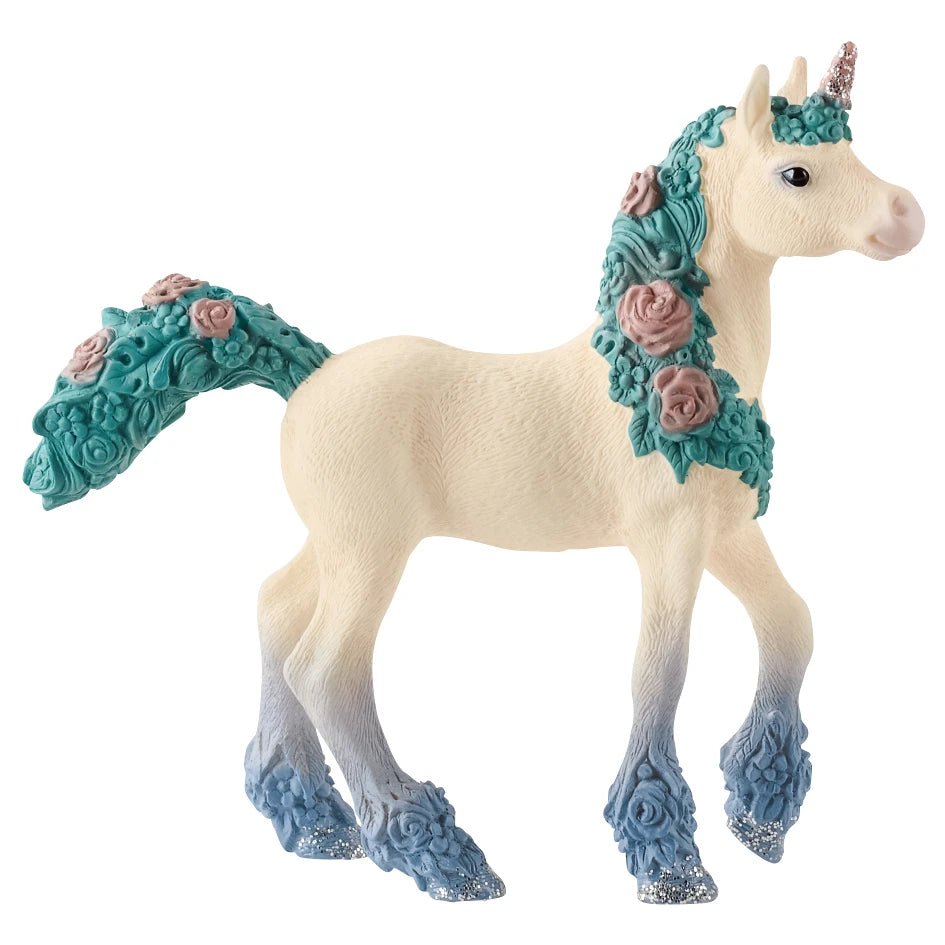 Decorative unicorn figurine with floral mane and tail on a white background