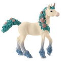 Decorative unicorn figurine with floral mane and tail on a white background