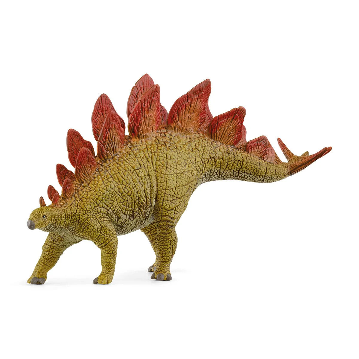 Dinosaur toy figure with red spikes on a white background